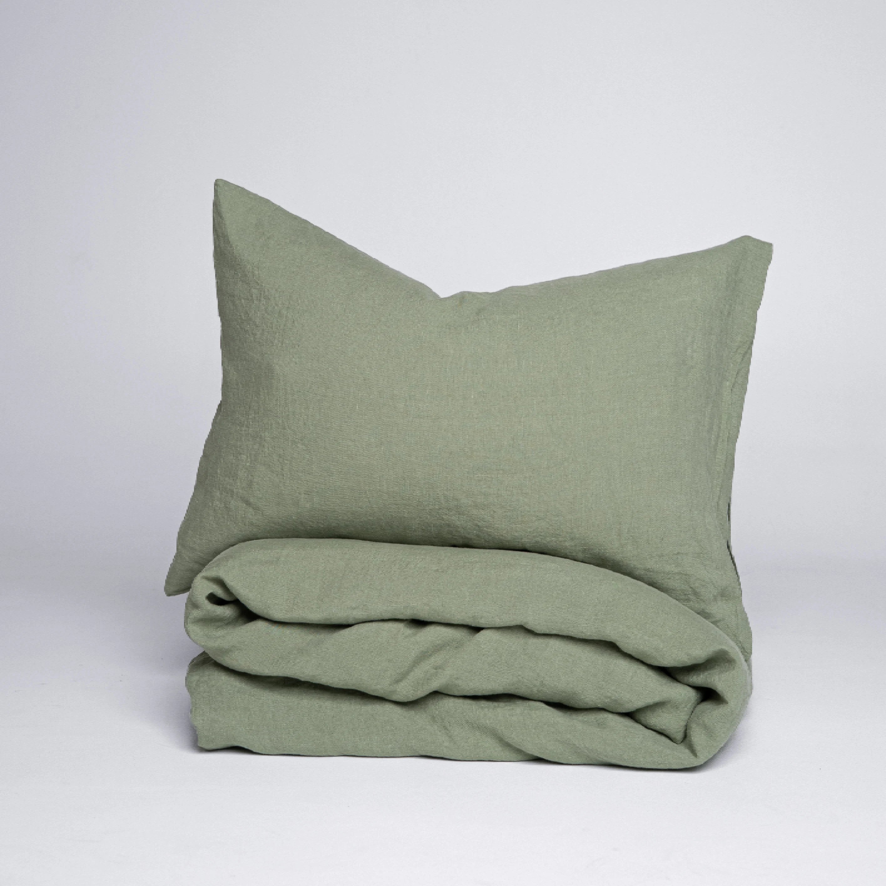 Soft sage green natural linen bedding with duvet cover and pillowcases.