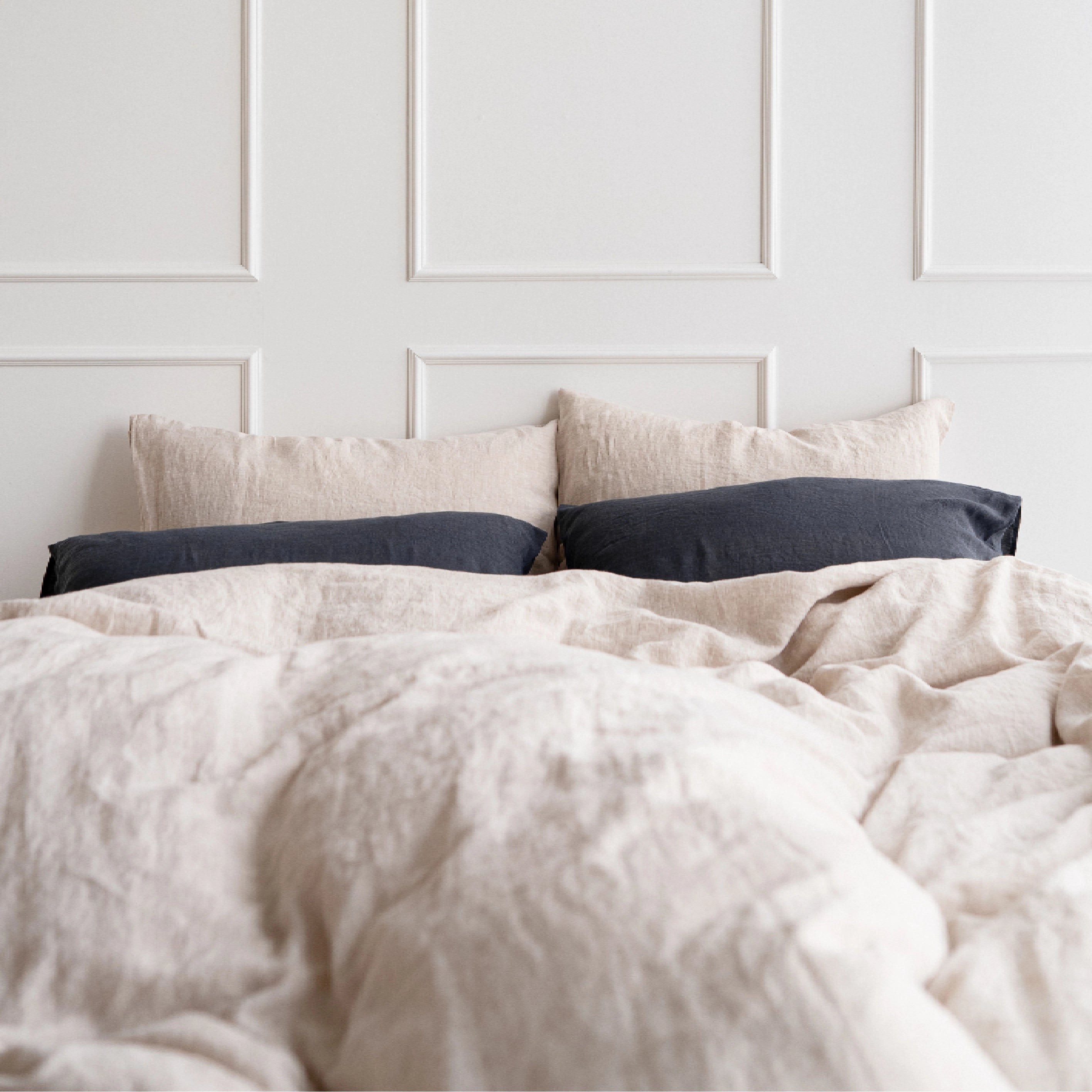 Handmade beige linen duvet cover showcasing stonewashed softness with grey pillows