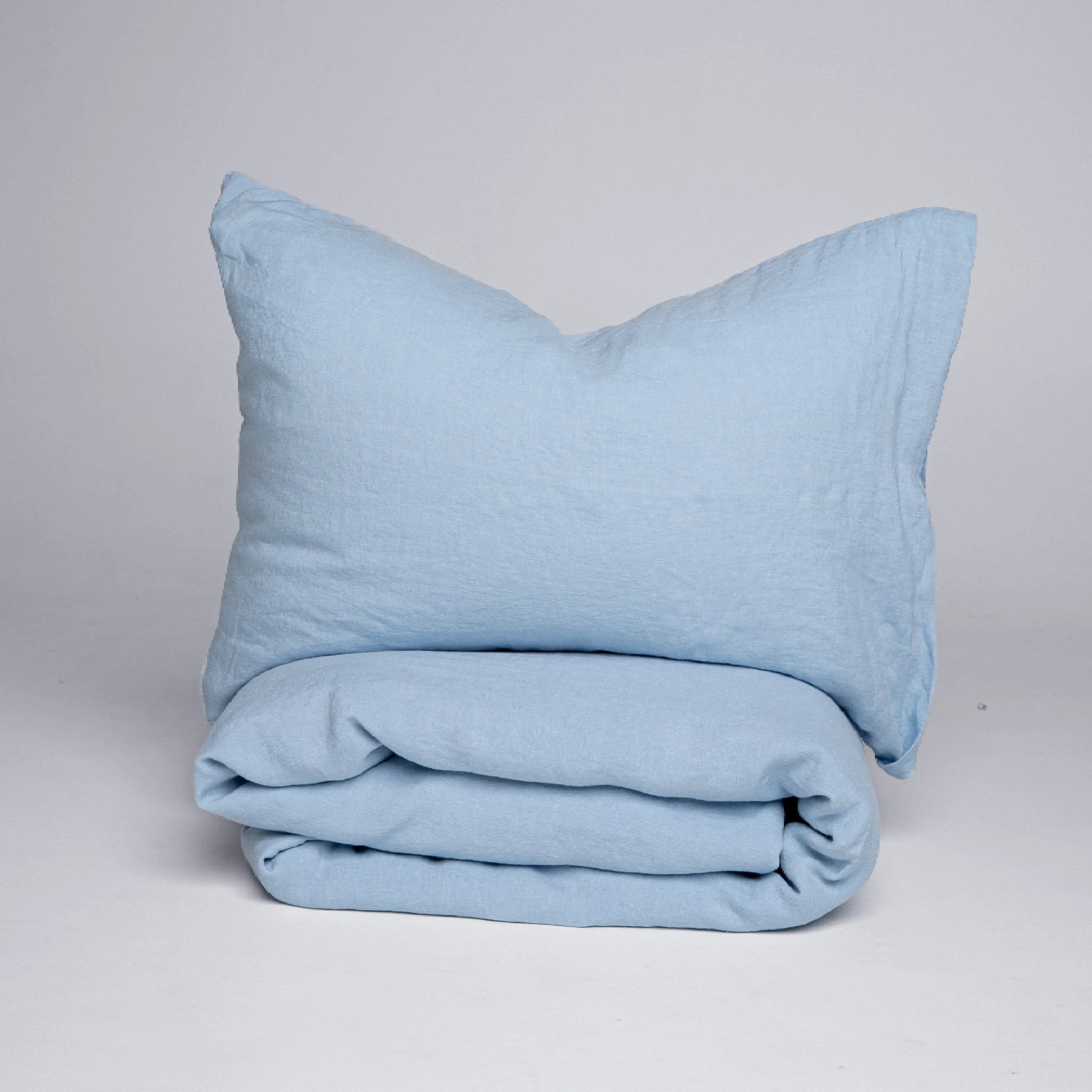 Soft powder blue natural linen bedding with duvet cover and pillowcases.