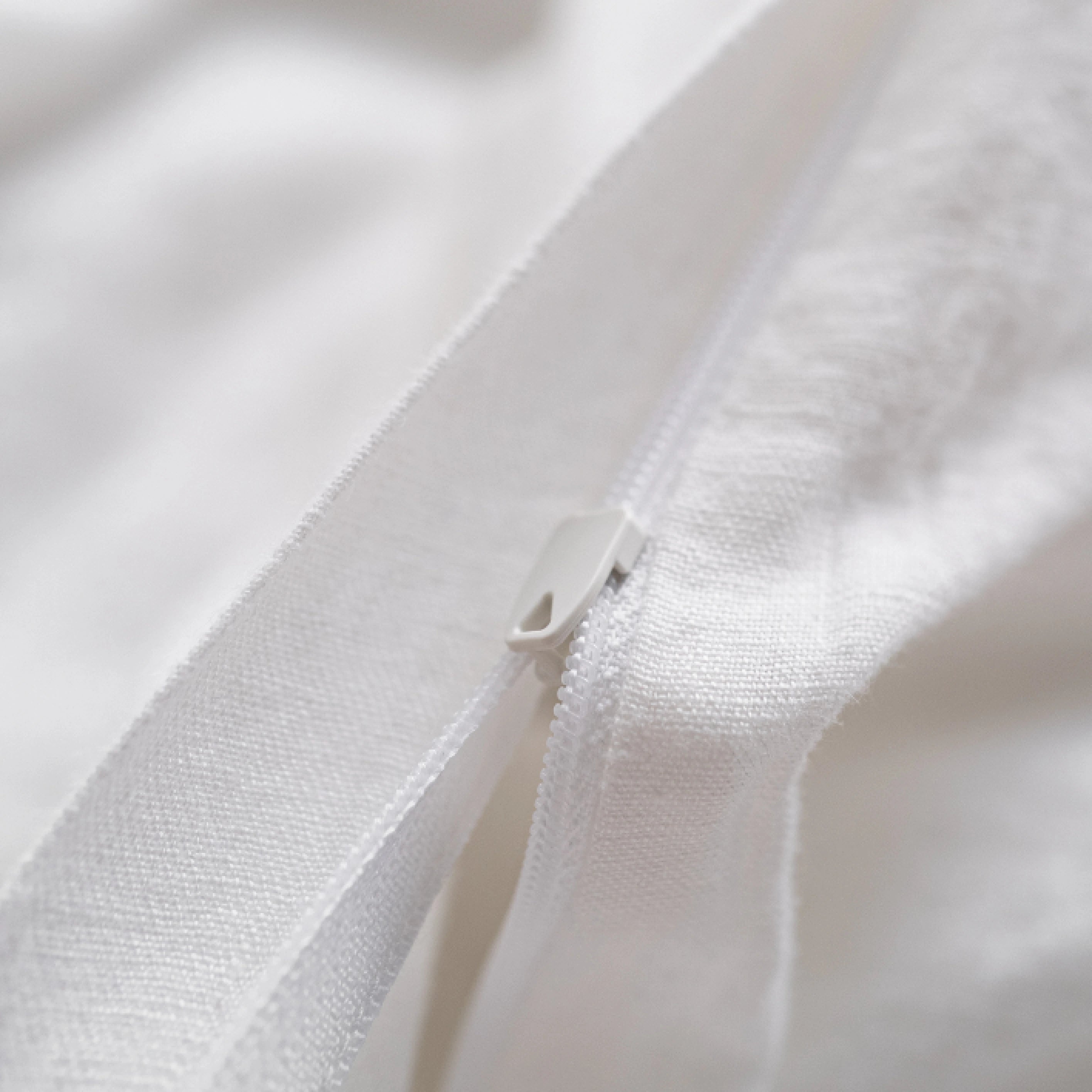 Handmade white linen duvet cover with hidden zipper closure.