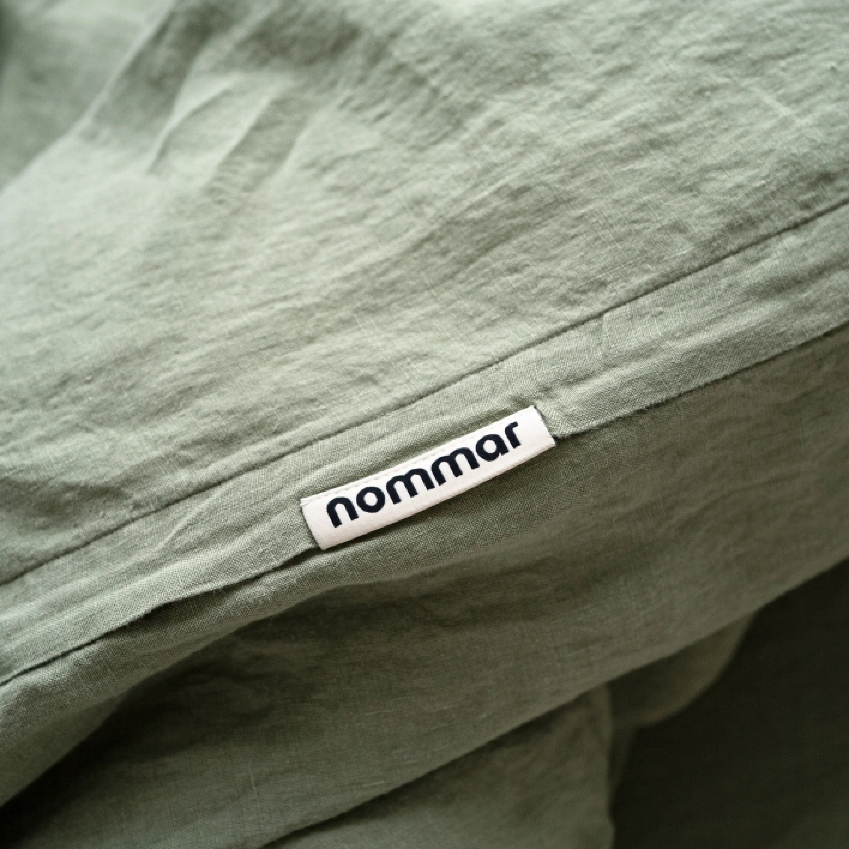 Moisture-wicking European flax linen bedding in sage green, handcrafted in Lithuania.