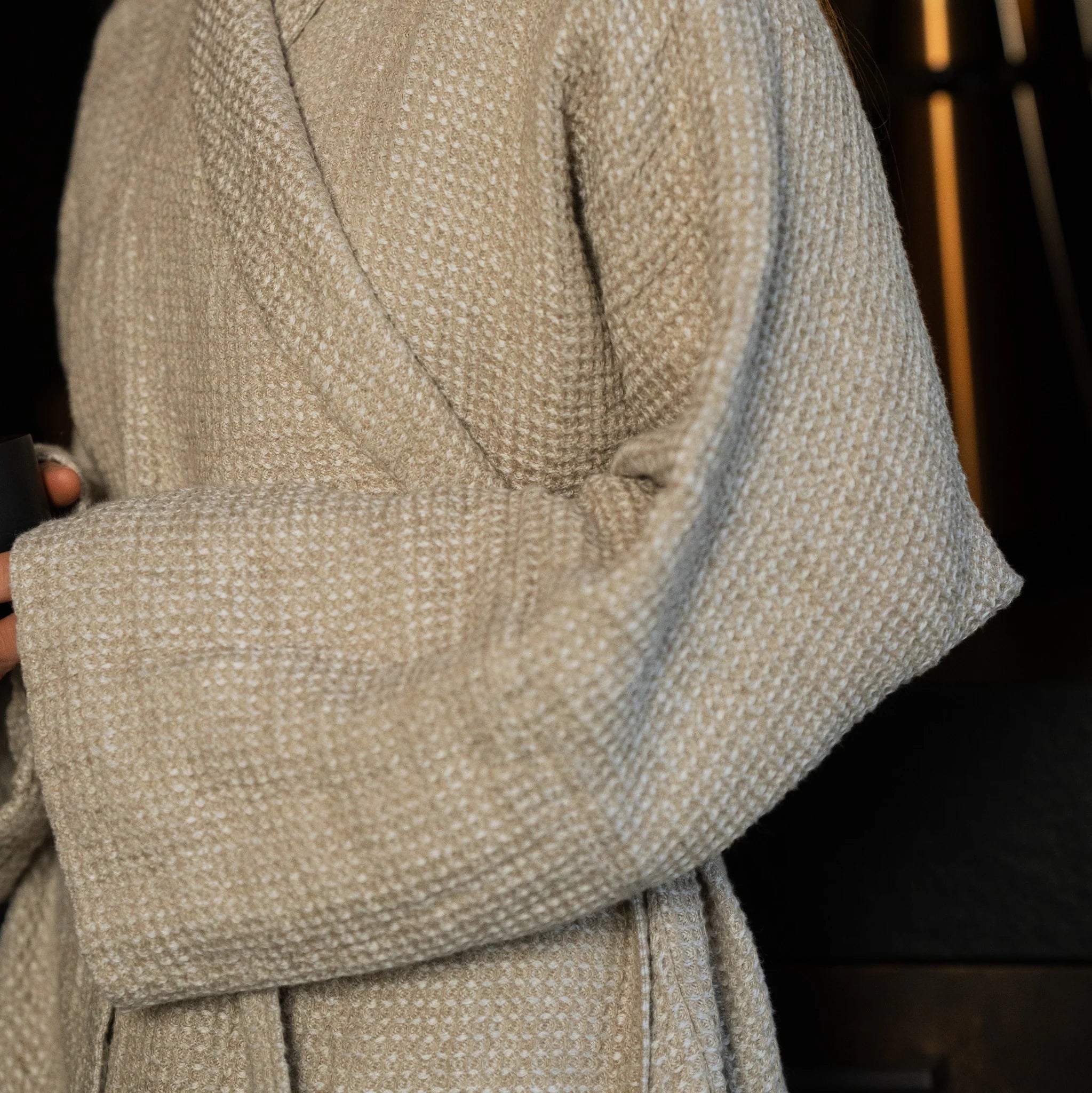 Beige linen robe featuring structured double-layer sleeves that hold their shape when rolled up