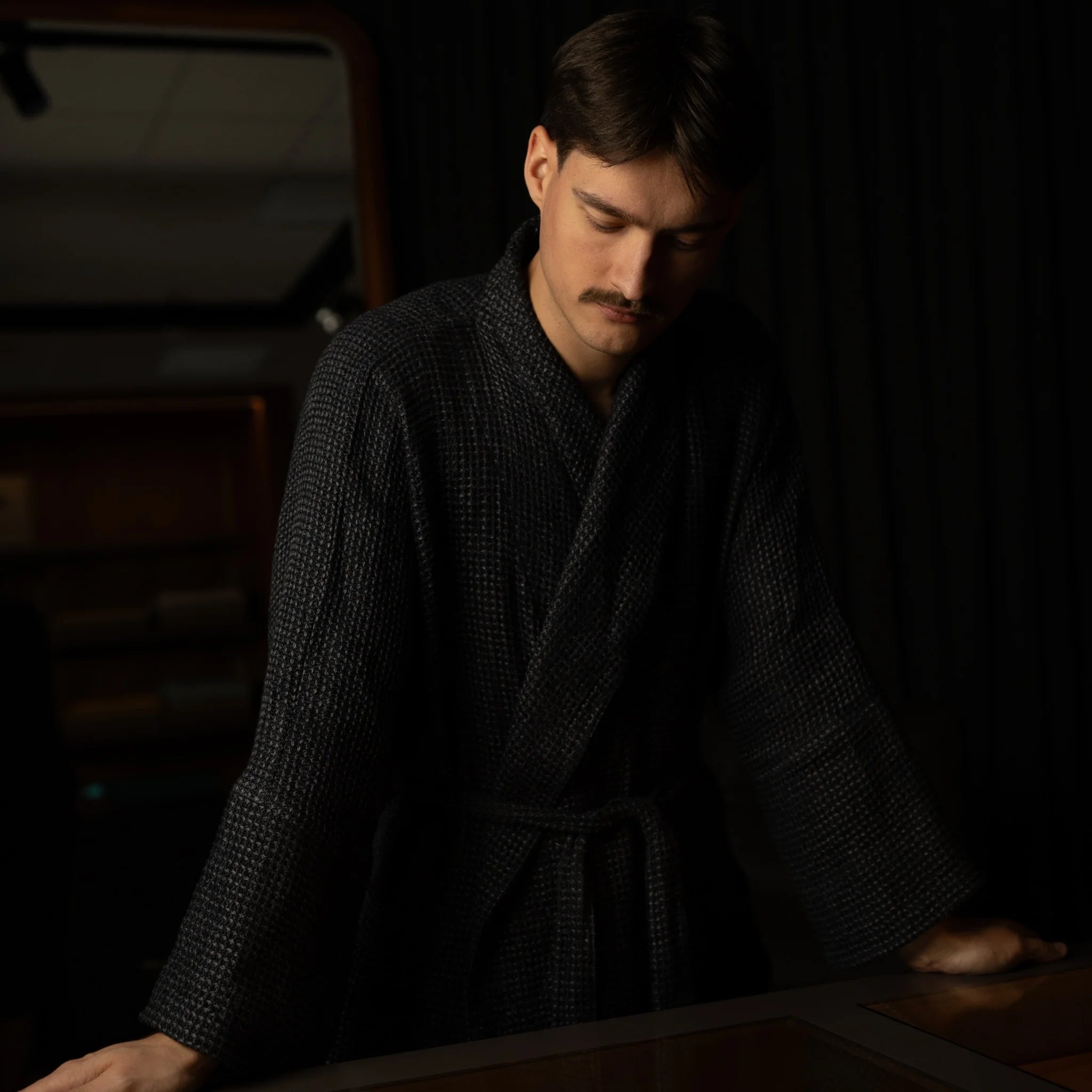 Dark Nommar Atelier Linen Robe fabric detail, black and grey linen yarns creating a subtle three-dimensional texture