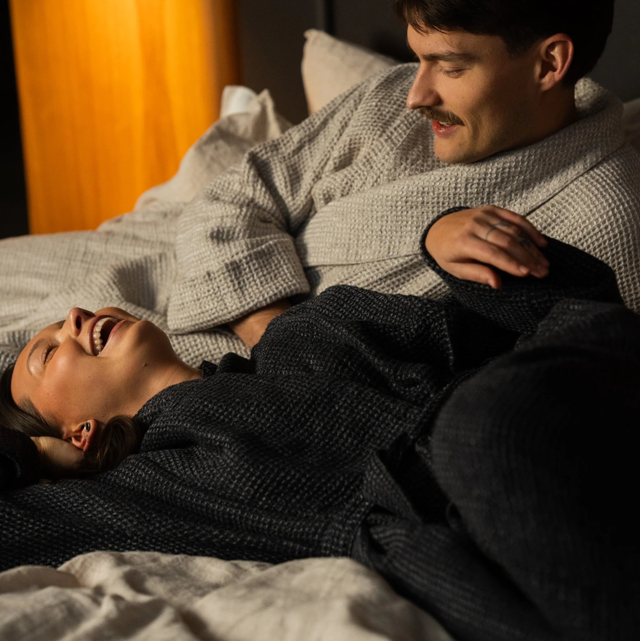 Nommar Atelier Linen Robe in light and dark tones, long unisex waffle linen robes styled in a calm bedroom setting