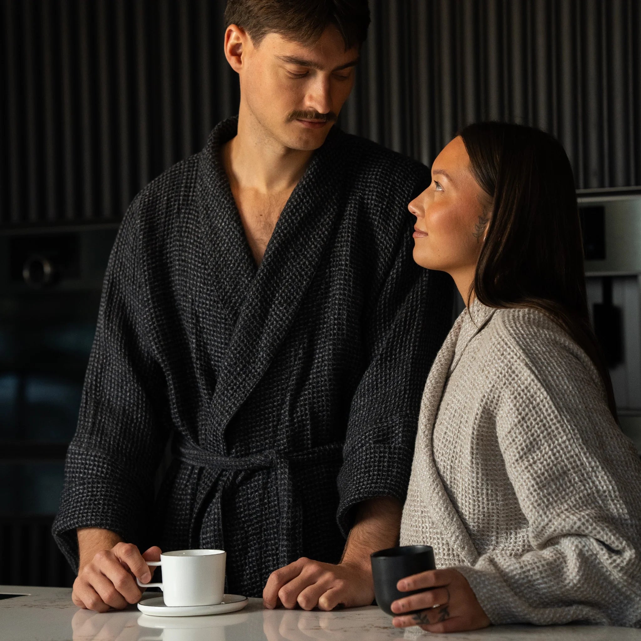 Model wearing Nommar Atelier Linen Robe in dark tone, highlighting the sculpted silhouette and dimensional waffle linen texture
