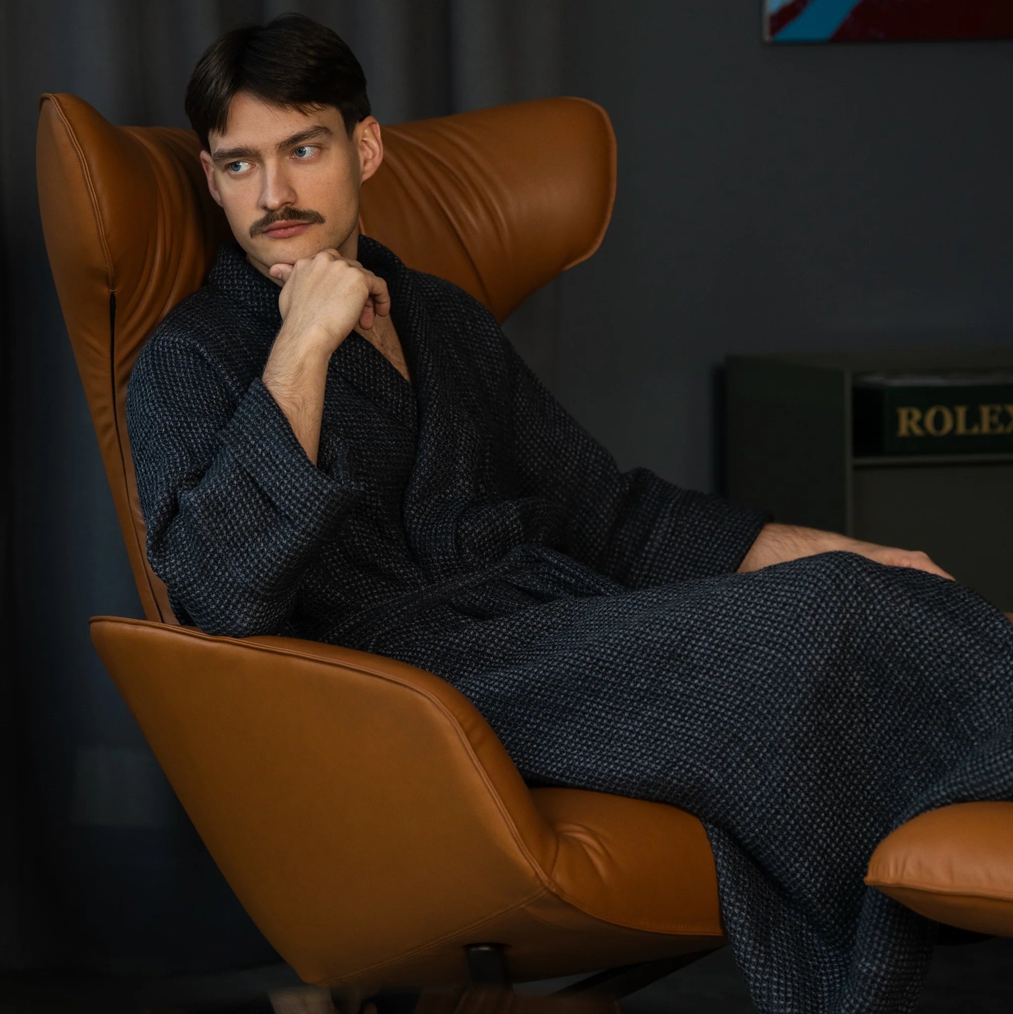 Man wearing Nommar Atelier Linen Robe in dark tone, long unisex waffle-textured linen with structured sleeves